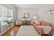 Cozy living room featuring hardwood floors, an accent chair, a sofa, and ample natural light at 2081 Township Dr, Woodstock, GA 30189