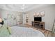 Spacious main bedroom with a fireplace, dresser, and doorway to ensuite bathroom at 2081 Township Dr, Woodstock, GA 30189