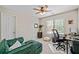 Home office/bedroom with green sleeper sofa, desk, and large window with tree view at 2081 Township Dr, Woodstock, GA 30189