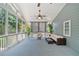 Cozy screened porch featuring comfortable seating, ceiling fan, and serene views of the outdoors at 2081 Township Dr, Woodstock, GA 30189