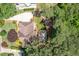 A high-angle aerial view of the home's roof and driveway surrounded by lush foliage and tree coverage at 410 Beechwood Ln, Woodstock, GA 30189