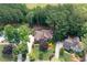 A sprawling home on a large lot, showcasing meticulous landscaping and mature trees, with neighboring properties nearby at 410 Beechwood Ln, Woodstock, GA 30189