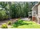 A lush backyard with a beautiful lawn, trees, and patio with a fire pit, ideal for outdoor relaxation and entertaining at 410 Beechwood Ln, Woodstock, GA 30189