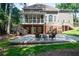Two story house with a deck overlooking the backyard with patio and fire pit at 410 Beechwood Ln, Woodstock, GA 30189