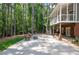Outdoor patio with wooded views and outdoor seating with a fire pit at 410 Beechwood Ln, Woodstock, GA 30189