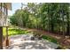 Backyard featuring a deck with seating, lush landscaping, and privacy fence at 410 Beechwood Ln, Woodstock, GA 30189