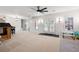 Spacious finished basement featuring neutral carpet, ceiling fan, and bright windows at 410 Beechwood Ln, Woodstock, GA 30189