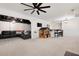 Spacious finished basement with a large black leather couch, ceiling fan and play area at 410 Beechwood Ln, Woodstock, GA 30189