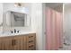 Updated bathroom with a modern mirror, light wood cabinets, and a pink shower curtain at 410 Beechwood Ln, Woodstock, GA 30189