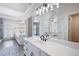 Luxurious bathroom with a double sink vanity, elegant lighting, and a walk-in shower at 410 Beechwood Ln, Woodstock, GA 30189