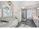 Bright bathroom featuring a soaking tub, walk-in shower, double vanity, and stylish finishes at 410 Beechwood Ln, Woodstock, GA 30189