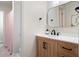 Updated bathroom featuring a wood vanity with black hardware and a shower with a pink curtain at 410 Beechwood Ln, Woodstock, GA 30189