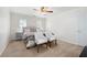 Bright bedroom featuring a bed, two sitting chairs, and natural light from the shuttered windows at 410 Beechwood Ln, Woodstock, GA 30189