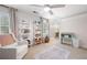 Neutral bedroom with a chair, ladder shelves with storage baskets, and a changing table at 410 Beechwood Ln, Woodstock, GA 30189