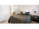 Cozy bedroom with a bed featuring a green comforter, bedside tables, and sconce lighting at 410 Beechwood Ln, Woodstock, GA 30189