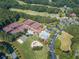 An aerial view showcasing the community's tennis courts, pool, and clubhouse amenities, nestled amidst lush greenery and trees at 410 Beechwood Ln, Woodstock, GA 30189