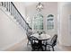 Cozy dining area with high ceilings, large windows with shutters, and staircase at 410 Beechwood Ln, Woodstock, GA 30189