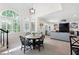 Open-concept dining area with staircase and large windows, seamlessly connecting to the living room at 410 Beechwood Ln, Woodstock, GA 30189