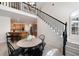 Charming dining area with stairway, seamlessly connecting to the kitchen with light wood flooring at 410 Beechwood Ln, Woodstock, GA 30189