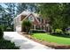 Lovely two-story brick home with a long driveway and attached two-car garage at 410 Beechwood Ln, Woodstock, GA 30189