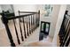 Elegant foyer featuring hardwood floors, black stair railing, and a decorative chandelier at 410 Beechwood Ln, Woodstock, GA 30189