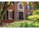 Elegant brick home with a double door entrance and manicured landscaping at 410 Beechwood Ln, Woodstock, GA 30189