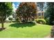 Stately brick home with a meticulously manicured front yard, mature landscaping, and a charming, inviting entrance at 410 Beechwood Ln, Woodstock, GA 30189