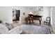 Cozy living room with a piano, fireplace, and hardwood floors at 410 Beechwood Ln, Woodstock, GA 30189