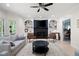 Bright living room with built-in bookshelves, fireplace, modern furniture, and a ceiling fan at 410 Beechwood Ln, Woodstock, GA 30189
