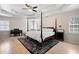Spacious main bedroom with a four poster bed, a trey ceiling, and hardwood floors at 410 Beechwood Ln, Woodstock, GA 30189