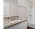 Bathroom featuring granite countertops, a modern sink, and a shower-tub combo for relaxation and functionality at 726 Alfred Nw Rd, Atlanta, GA 30331