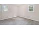 This carpeted bedroom gets natural light with a double set of windows and neutral walls at 726 Alfred Nw Rd, Atlanta, GA 30331