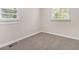 Comfortable bedroom with two windows letting in natural light, and featuring neutral carpet and fresh white trim at 726 Alfred Nw Rd, Atlanta, GA 30331