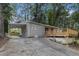 Well-maintained house with a carport and a wooden deck, accessible via a concrete driveway and backyard at 726 Alfred Nw Rd, Atlanta, GA 30331
