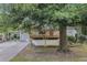 Charming home featuring a large wooden deck and an ample-sized front yard surrounded by lush trees at 726 Alfred Nw Rd, Atlanta, GA 30331