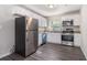 Modern kitchen features white cabinetry, granite countertops, and stainless-steel appliances, ideal for cooking at 726 Alfred Nw Rd, Atlanta, GA 30331