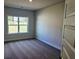 A cozy bedroom with new carpet and a bright window offering natural light and serene views at 112 Scarlett Place Dr, Bowdon, GA 30108