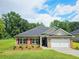 Charming brick home with a well-manicured lawn, attached garage, and beautiful landscaping at 112 Scarlett Place Dr, Bowdon, GA 30108