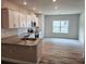 Spacious kitchen featuring granite counters and stainless steel appliances and wood flooring at 112 Scarlett Place Dr, Bowdon, GA 30108