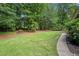 Expansive backyard offers a level lawn, mature trees, planting beds and plenty of space for outdoor activities at 2502 Tritt Springs Ne Trce, Marietta, GA 30062