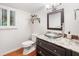 Bathroom featuring granite countertop, glass sink, framed mirror, and a window with shutters at 2502 Tritt Springs Ne Trce, Marietta, GA 30062