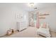 Cozy bedroom with white walls, carpet, a window, a dresser, and decor art at 2502 Tritt Springs Ne Trce, Marietta, GA 30062