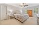 Bright bedroom boasts neutral colors, ceiling fan, carpet, and two windows for ample natural light at 2502 Tritt Springs Ne Trce, Marietta, GA 30062