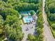 Aerial view features the community pool, tennis courts, parking, landscaping and the adjacent road at 2502 Tritt Springs Ne Trce, Marietta, GA 30062