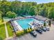 Aerial shot showcases a community pool with lounge chairs, tennis courts, mature landscaping, and ample parking at 2502 Tritt Springs Ne Trce, Marietta, GA 30062