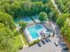 The community pool area features lush landscaping, tennis courts, lounge chairs, and easy parking at 2502 Tritt Springs Ne Trce, Marietta, GA 30062