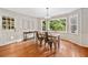 Charming dining area with a large window, wood table and flooring, and classic wainscoting at 2502 Tritt Springs Ne Trce, Marietta, GA 30062