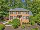 Charming two-story brick home with a well-manicured lawn and mature trees at 2502 Tritt Springs Ne Trce, Marietta, GA 30062