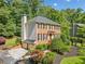 Brick home features a two-car garage, beautiful landscaping, and a wooded lot at 2502 Tritt Springs Ne Trce, Marietta, GA 30062