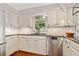 Updated kitchen featuring white cabinets, a modern faucet, and sleek stainless steel dishwasher at 2502 Tritt Springs Ne Trce, Marietta, GA 30062